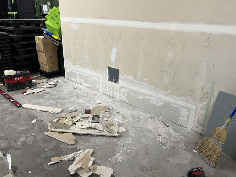 Damaged lower wall opened up for repair at a commercial site