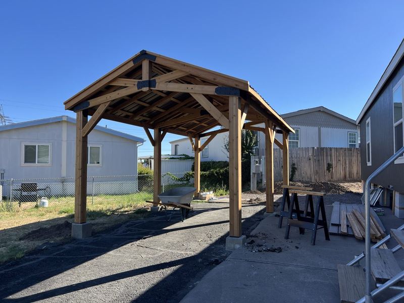 The finished timber-frame pavilion with metal roof